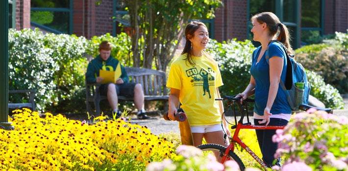 Transfer Students Chatting Students chatting and laughing on a sunny summer day.