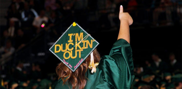 Graduating Student Ducking Out A graduating student, with "I'm ducking out" on her cap, gives a proud thumbs up.