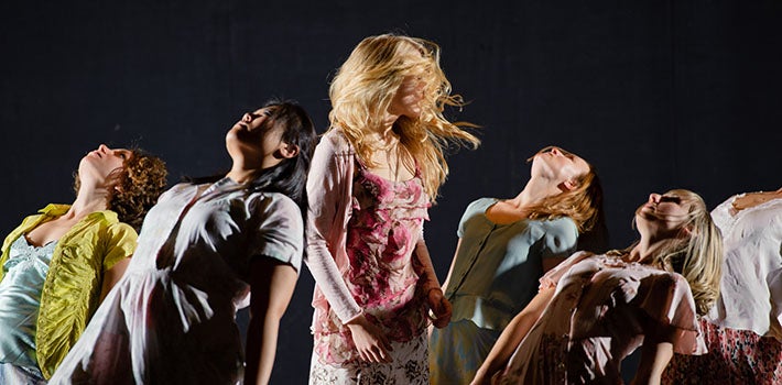 Six Female Students Dancing Together Five female students lean back, striking a pose as a blonde woman twirls in the center.