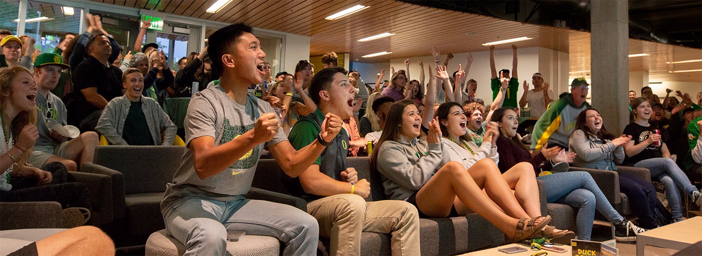 Students cheering at the student union Students cheering at the student union