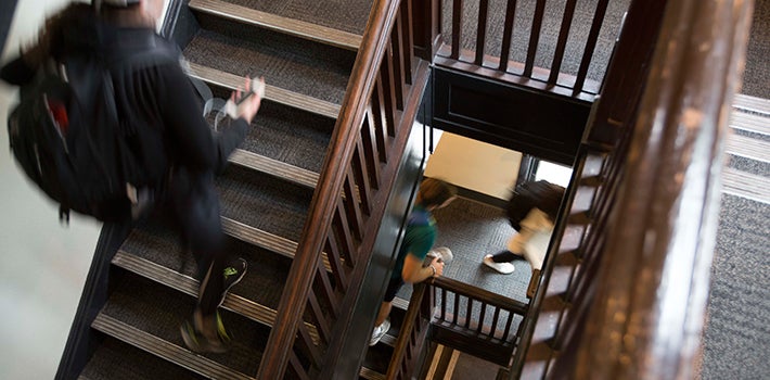 Students taking the stairs to class in Deady Hall.