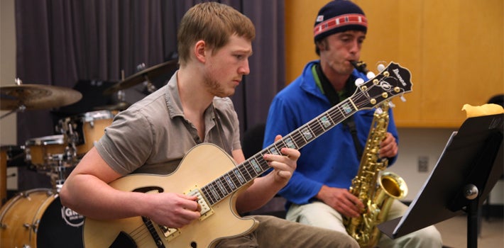 Jazz Guitar and Sax A jazz guitarist and saxophonist practicing together