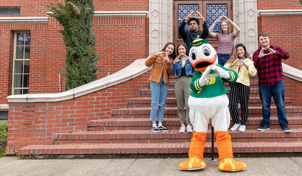 Duck and students showing O hands!