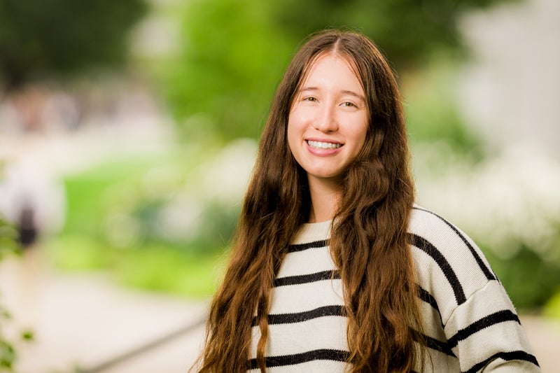 Eleanor Yi wearing a white sweater with black horizontal stripes