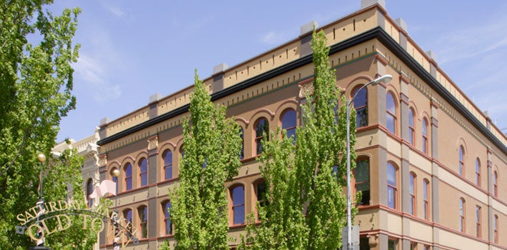 A building right behind the sign for 'Old Town' , blocked by some trees.