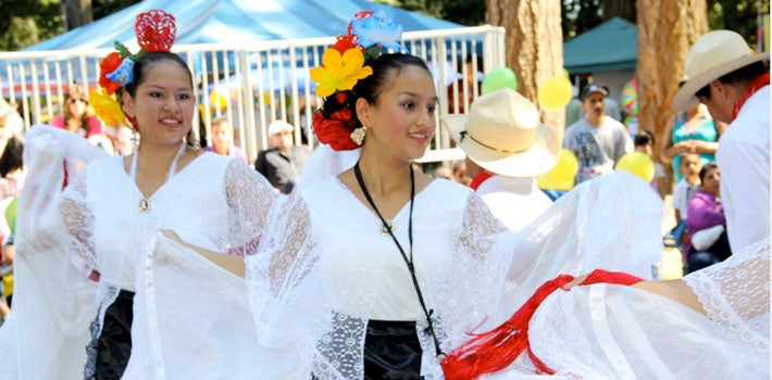 Two girls dancing in white dresses.