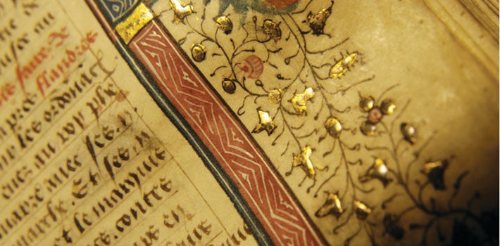 Golden artwork aside medieval text.