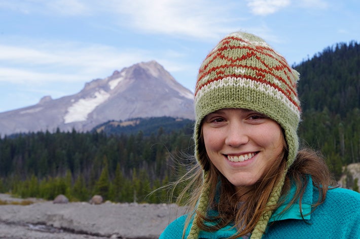 Geography student in front of a mountain